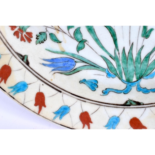 460 - A LARGE MIDDLE EASTERN TURKISH IZNIK PLATE painted with flowers. 30 cm diameter.