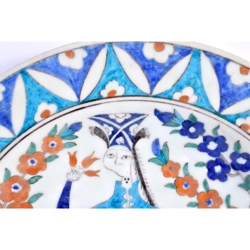 461 - A LARGE MIDDLE EASTERN TURKISH KUTAHYA PLATE painted with a figure. 30 cm diameter.