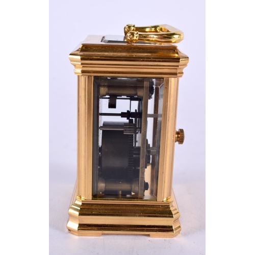 469 - A CONTEMPORARY MINIATURE BRASS CARRIAGE CLOCK. 10 cm x 5 cm.