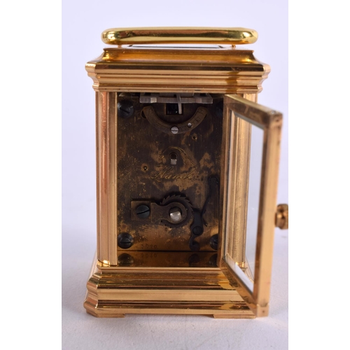 469 - A CONTEMPORARY MINIATURE BRASS CARRIAGE CLOCK. 10 cm x 5 cm.