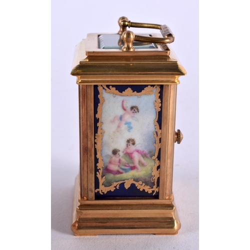 470 - A CONTEMPORARY MINIATURE PUTTI BRASS CARRIAGE CLOCK. 10 cm x 5 cm.