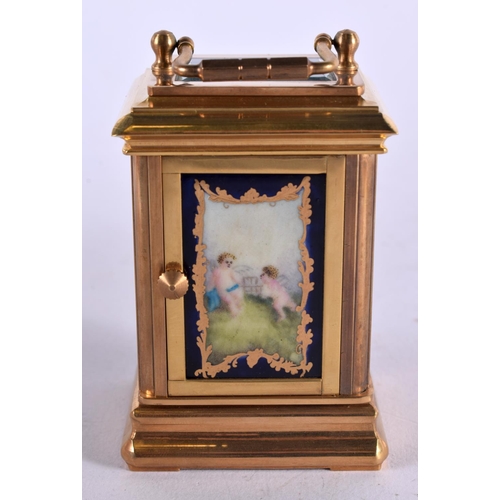 470 - A CONTEMPORARY MINIATURE PUTTI BRASS CARRIAGE CLOCK. 10 cm x 5 cm.