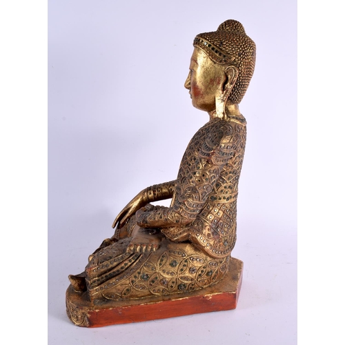 501 - A LARGE SOUTH EAST ASIAN POLYCHROMED WOOD FIGURE OF.A BUDDHA. 45 cm x 25 cm.