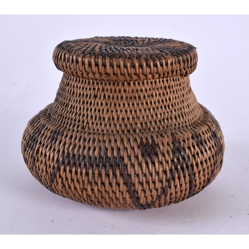 509 - AN EARLY 20TH CENTURY TRIBAL CARVED WICKER WORK ROTI BASKET. 12 cm x 10 cm.