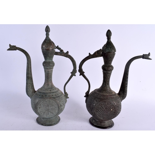 528 - A PAIR OF 19TH CENTURY MIDDLE EASTERN BRONZED COPPER EWERS decorated with foliage and vines. 32 cm x... 