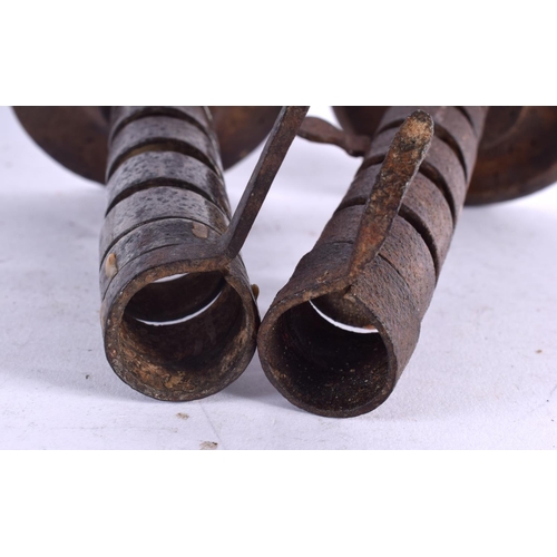 530 - TWO EARLY IRON PIG TAIL TWIST COUNTRY CANDLESTICKS. 20 cm high.