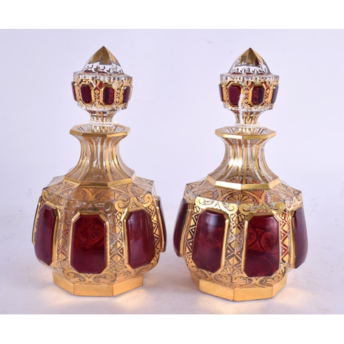 54 - A FINE PAIR OF 19TH CENTURY BOHEMIAN RUBY AND GILT GLASS SCENT BOTTLES painted with motifs. 13 cm x ... 