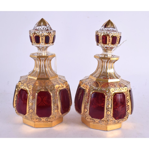 54 - A FINE PAIR OF 19TH CENTURY BOHEMIAN RUBY AND GILT GLASS SCENT BOTTLES painted with motifs. 13 cm x ... 