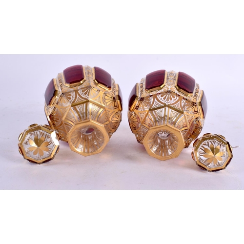 54 - A FINE PAIR OF 19TH CENTURY BOHEMIAN RUBY AND GILT GLASS SCENT BOTTLES painted with motifs. 13 cm x ... 