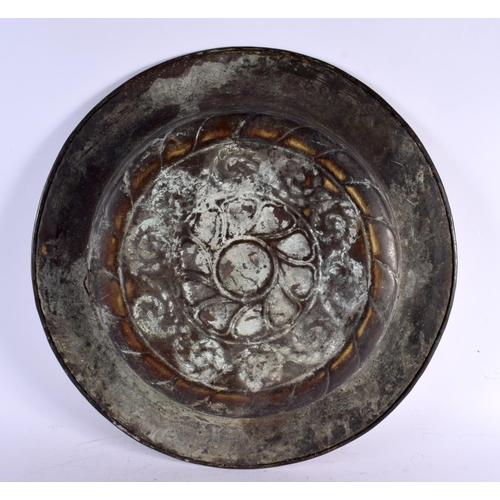 557 - A LARGE 18TH CENTURY EUROPEAN BRASS ALMS DISH decorated with repousse motifs. 48 cm diameter.