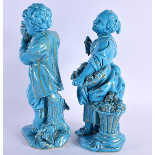 57 - A PAIR OF 19TH BLUE GLAZED PORCELAIN FIGURES OF A BOY AND GIRL Minton or Sevres, painted with gilt f... 