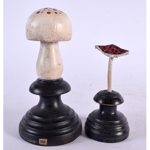 593 - TWO CARVED TAXIDERMY TYPE PAINTED FOLK ART MOUSHROOMS. Largest 15 cm high. (2)