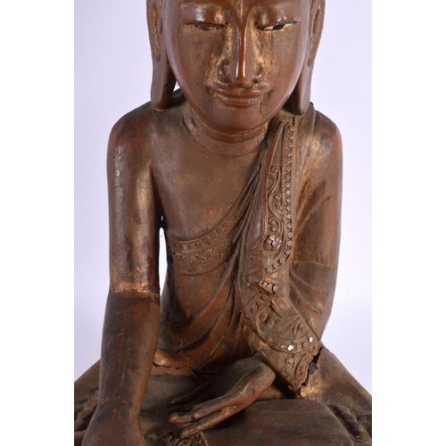 606 - AN EARLY 20TH CENTURY INDIAN LACQUERED WOOD FIGURE OF A BUDDHA. 42 cm x 28 cm.