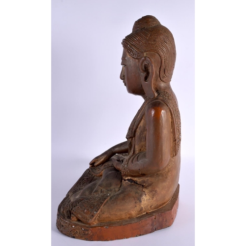 606 - AN EARLY 20TH CENTURY INDIAN LACQUERED WOOD FIGURE OF A BUDDHA. 42 cm x 28 cm.