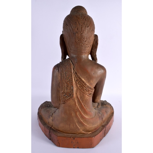 606 - AN EARLY 20TH CENTURY INDIAN LACQUERED WOOD FIGURE OF A BUDDHA. 42 cm x 28 cm.