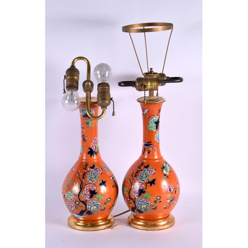 609 - A PAIR OF 19TH CENTURY ENGLISH PORCELAIN COUNTRY HOUSE LAMPS painted with flowers upon a coral groun... 