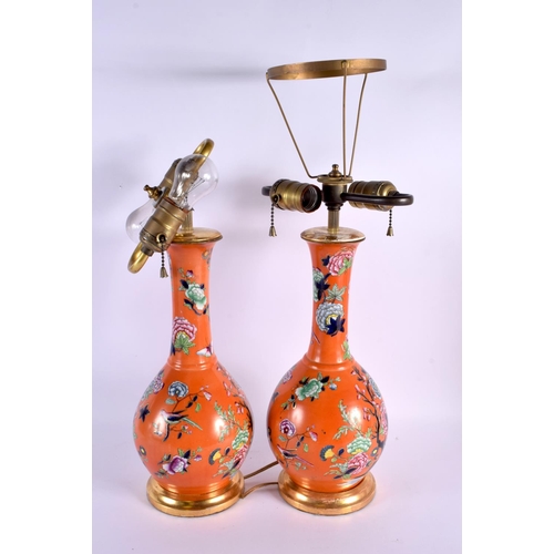 609 - A PAIR OF 19TH CENTURY ENGLISH PORCELAIN COUNTRY HOUSE LAMPS painted with flowers upon a coral groun... 