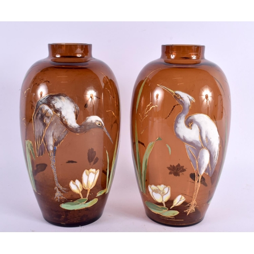 61 - A PAIR OF 19TH CENTURY EUROPEAN AESTHETIC MOVEMENT GLASS VASES enamelled with herons/cranes within l... 