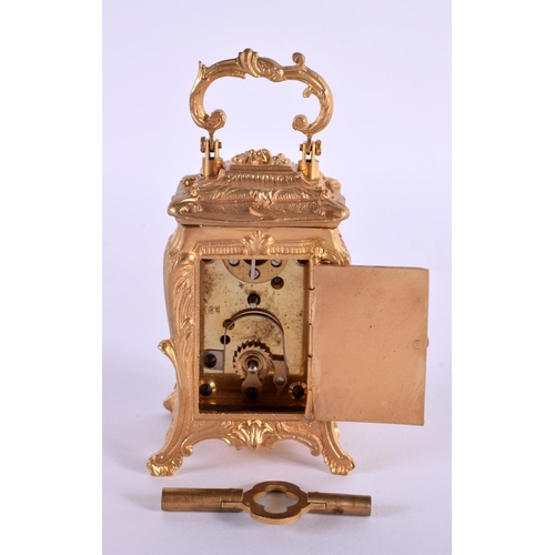 611 - A CONTEMPORARY MINIATURE BRASS ROCOCO CARRIAGE CLOCK. 9.5 cm high inc handle.