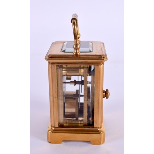 612 - A CONTEMPORARY MINIATURE BRASS SILVERED DIAL CARRIAGE CLOCK. 7.5 cm high inc handle.