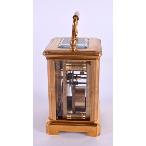 612 - A CONTEMPORARY MINIATURE BRASS SILVERED DIAL CARRIAGE CLOCK. 7.5 cm high inc handle.