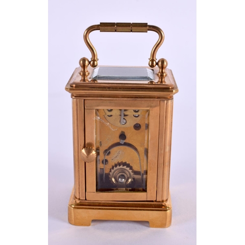 612 - A CONTEMPORARY MINIATURE BRASS SILVERED DIAL CARRIAGE CLOCK. 7.5 cm high inc handle.