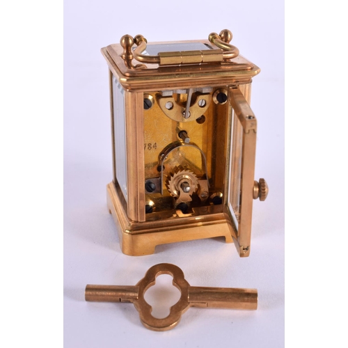 612 - A CONTEMPORARY MINIATURE BRASS SILVERED DIAL CARRIAGE CLOCK. 7.5 cm high inc handle.