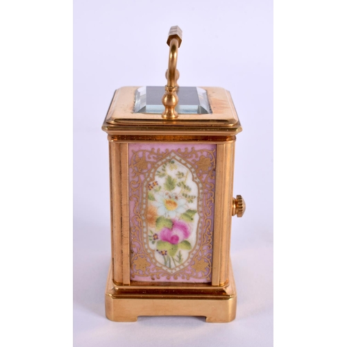 613 - A CONTEMPORARY MINIATURE BRASS PORCELAIN CARRIAGE CLOCK. 7.5 cm high inc handle.