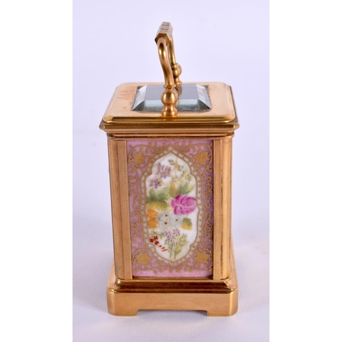 613 - A CONTEMPORARY MINIATURE BRASS PORCELAIN CARRIAGE CLOCK. 7.5 cm high inc handle.