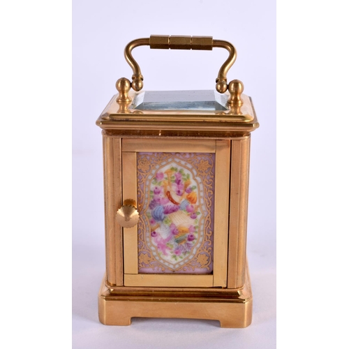 613 - A CONTEMPORARY MINIATURE BRASS PORCELAIN CARRIAGE CLOCK. 7.5 cm high inc handle.