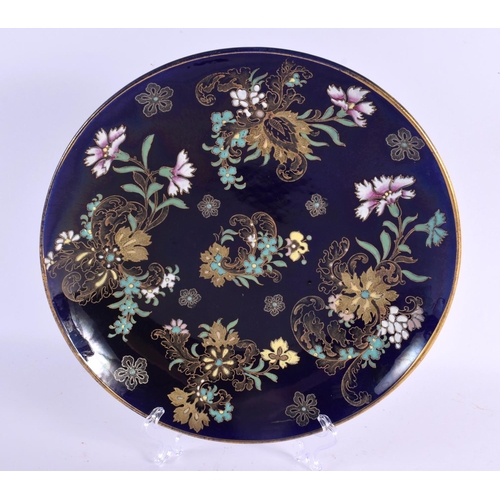 63 - AN ART NOUVEAU FRENCH ENAMELLED BLUE PLATE painted with raised enamel foliage. 28 cm diameter.