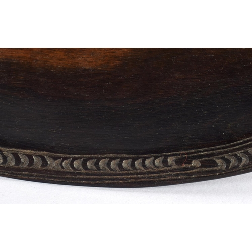 638 - AN UNUSUAL TRIBAL POLYNESIAN MAORI CARVED WOOD DISH decorated with motifs. 25 cm x 10 cm.