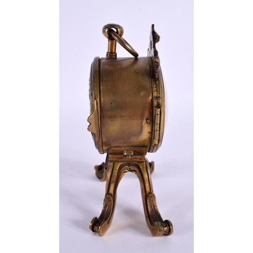 651 - AN EARLY 19TH CENTURY FRENCH GILT BRONZE MANTEL CLOCK upon scrolling rococo feet. 14 cm x 8 cm.