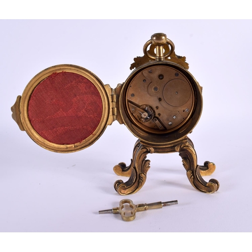 651 - AN EARLY 19TH CENTURY FRENCH GILT BRONZE MANTEL CLOCK upon scrolling rococo feet. 14 cm x 8 cm.