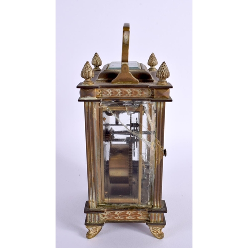 658 - AN EARLY 20TH CENTURY FRENCH BRASS BOUND CARRIAGE CLOCK with foliate enamel dial. 16 cm high inc han... 