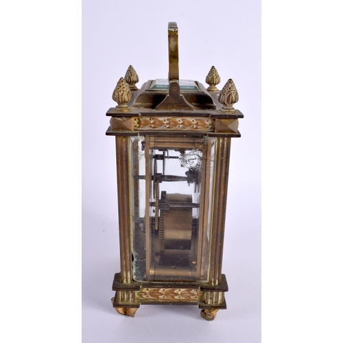 658 - AN EARLY 20TH CENTURY FRENCH BRASS BOUND CARRIAGE CLOCK with foliate enamel dial. 16 cm high inc han... 