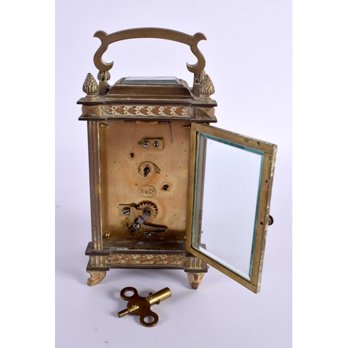 658 - AN EARLY 20TH CENTURY FRENCH BRASS BOUND CARRIAGE CLOCK with foliate enamel dial. 16 cm high inc han... 