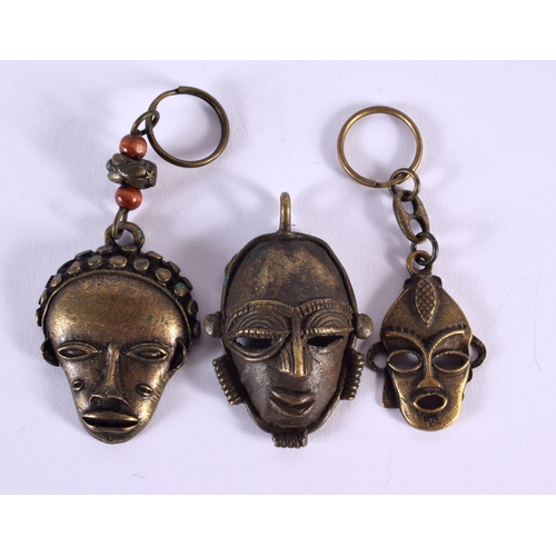 660 - FIVE ASSORTED TRIBAL BRONZE MASKS together with two censers. (7)