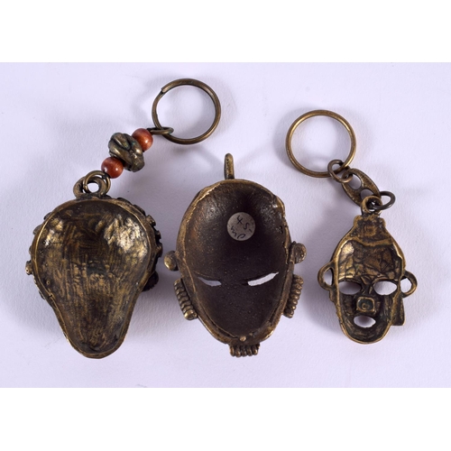 660 - FIVE ASSORTED TRIBAL BRONZE MASKS together with two censers. (7)