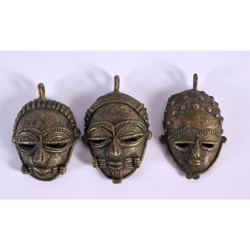 660 - FIVE ASSORTED TRIBAL BRONZE MASKS together with two censers. (7)