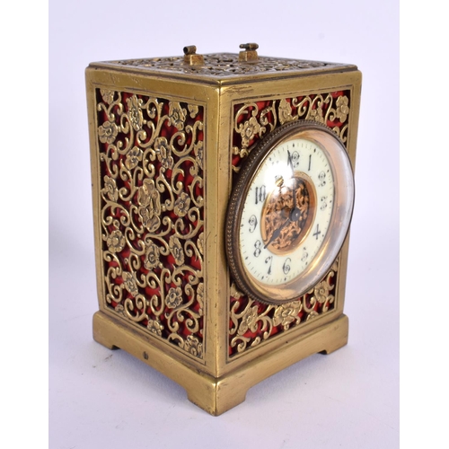 663 - AN ANTIQUE GILT METAL OPENWORK CARRIAGE CLOCK. 12 cm x 7.5 cm.