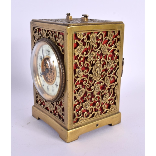 663 - AN ANTIQUE GILT METAL OPENWORK CARRIAGE CLOCK. 12 cm x 7.5 cm.