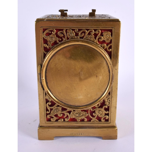 663 - AN ANTIQUE GILT METAL OPENWORK CARRIAGE CLOCK. 12 cm x 7.5 cm.