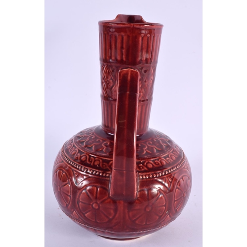 67 - AN ARTS AND CRAFTS RED POTTERY JUG Attributed to Dr Christopher Dresser. 25 cm x 13 cm.