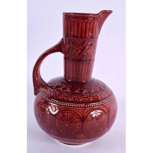 67 - AN ARTS AND CRAFTS RED POTTERY JUG Attributed to Dr Christopher Dresser. 25 cm x 13 cm.