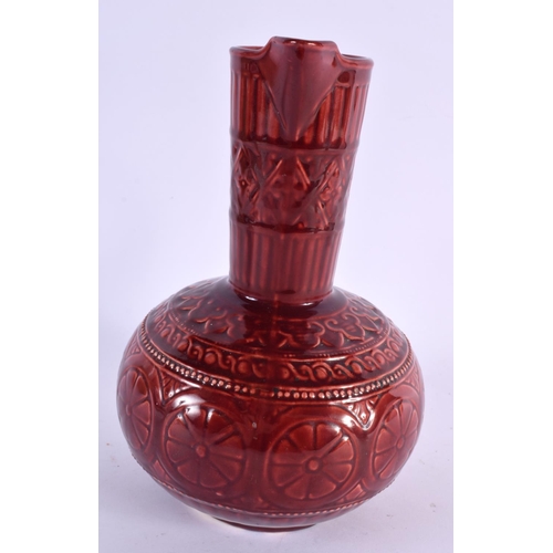 67 - AN ARTS AND CRAFTS RED POTTERY JUG Attributed to Dr Christopher Dresser. 25 cm x 13 cm.