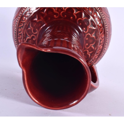 67 - AN ARTS AND CRAFTS RED POTTERY JUG Attributed to Dr Christopher Dresser. 25 cm x 13 cm.