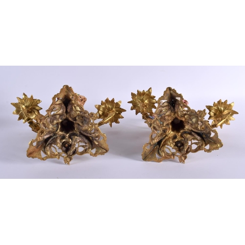 675 - A PAIR OF 19TH CENTURY CONTINENTAL PORCELAIN AND BRONZE CANDLESTICKS formed with figures amongst vin... 