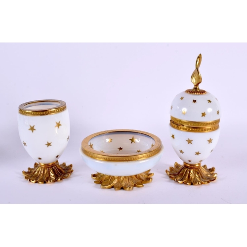 698 - AN ART DECO FRENCH OPALINE GLASS AND GILT METAL DESK SET painted with stars. Largest 15 cm high. (3)