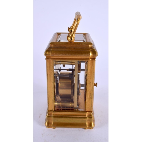 708 - A MINIATURE ANTIQUE FRENCH BRASS CARRIAGE CLOCK. 9.5 cm high inc handle.